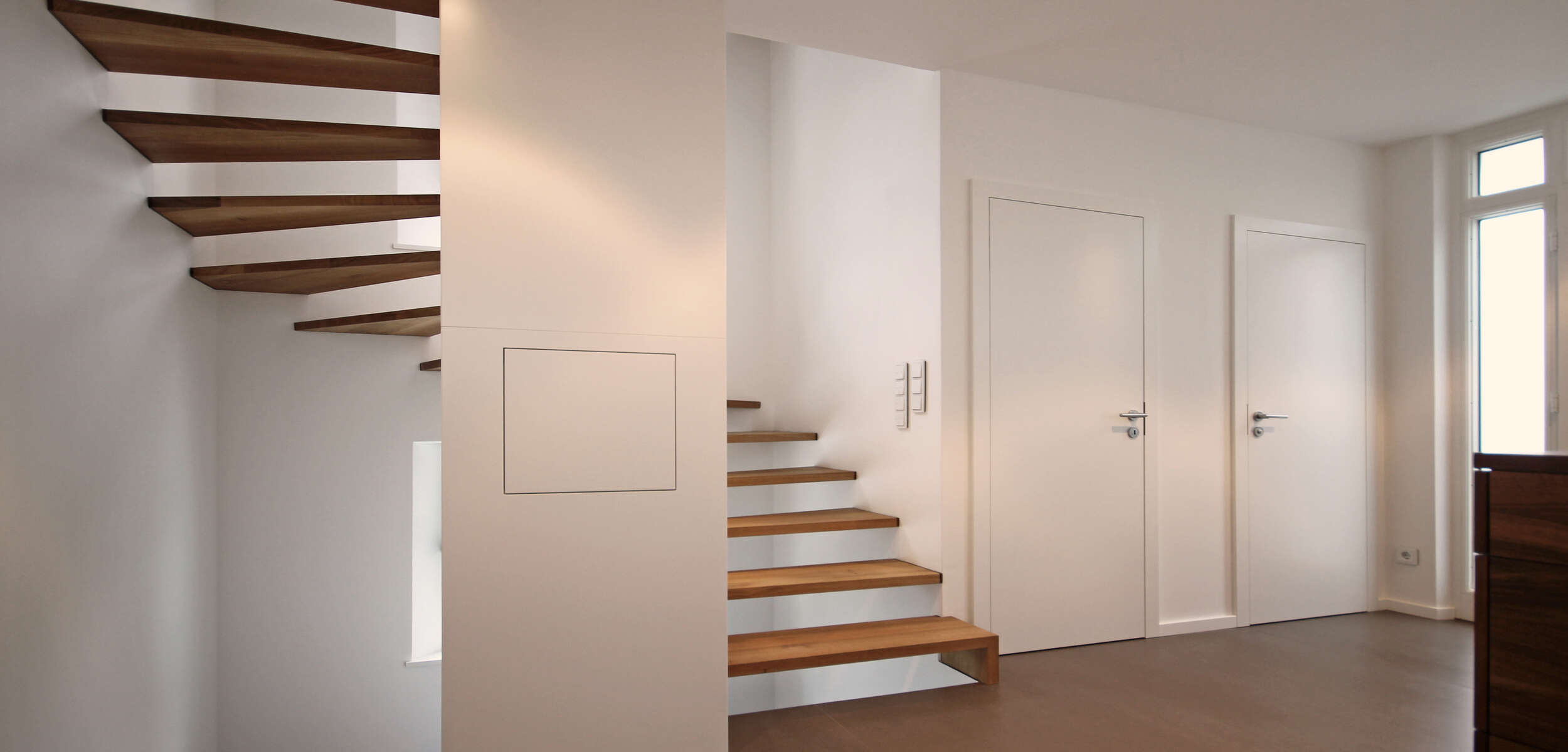 Stilvolle und elegante Holztreppe mit modernem Design in einem umgebauten Einfamilienhaus in München.