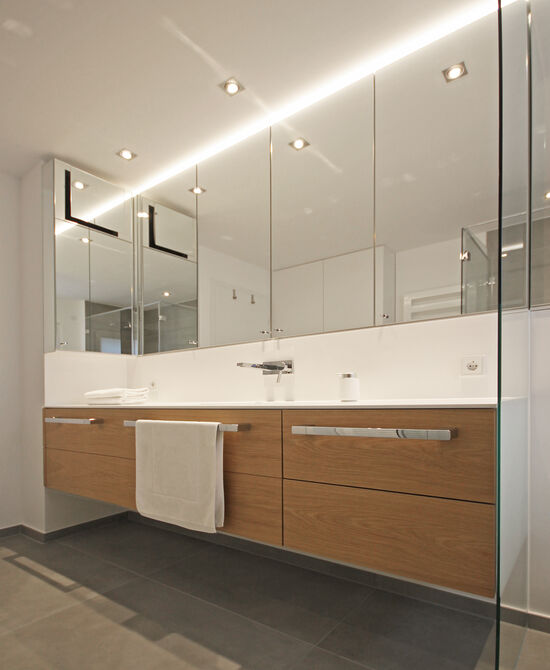 Innenarchitekt Andreas Ptatscheck, München, optimierte den Grundriss des Bauträgers und entwarf die Innenarchitektur und das Interior Design für das Badezimmer mit Waschtisch und einem Spiegelschrank mit Beleuchtung.